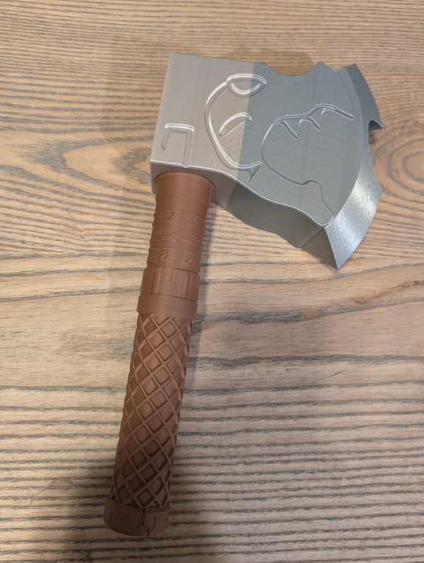 3D-printed dice-rolling axe, grey engraved head with a brown textured handle
